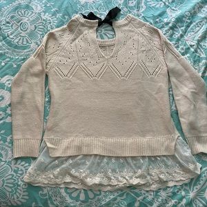 Super cute sweater with back bow tie and lace trim.